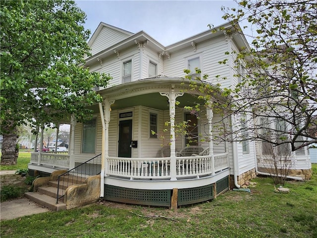 italianate home featuring a porch and a front lawn