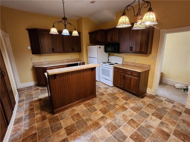kitchen with white appliances, a center island, light countertops, baseboards, and stone tile flooring