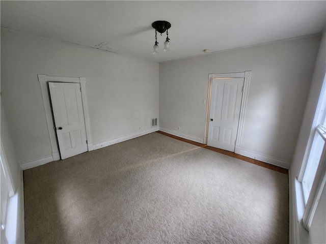 unfurnished room featuring baseboards