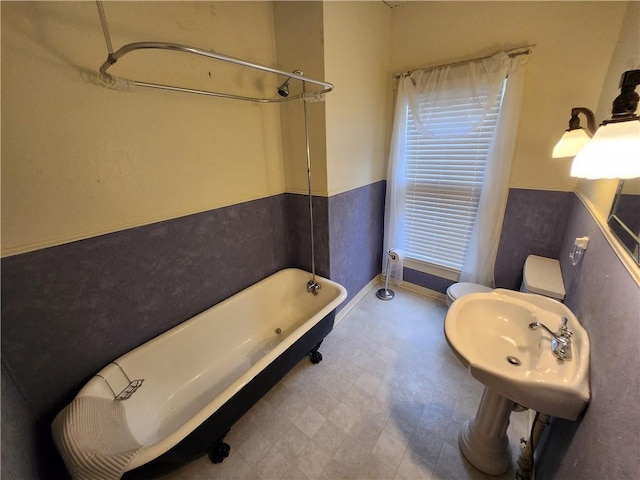 bathroom featuring a sink, toilet, a shower, a tub to relax in, and tile patterned floors