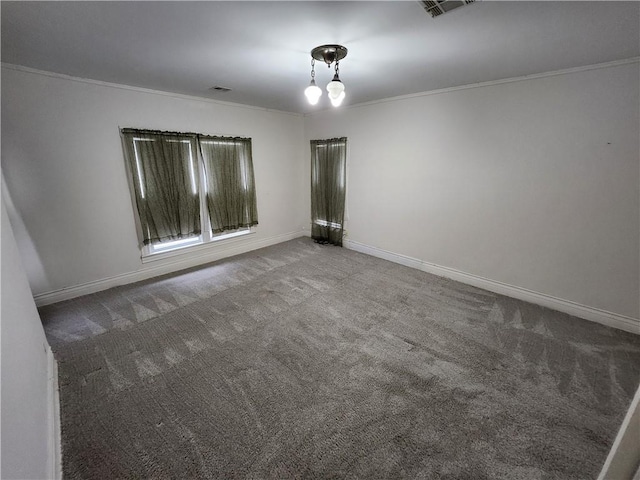 carpeted empty room with crown molding, baseboards, and visible vents