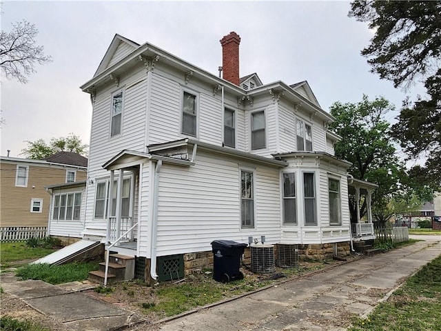 view of property exterior featuring a chimney