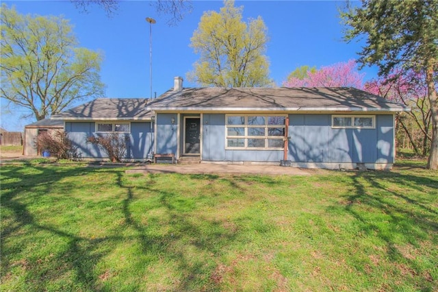 25388 Chieftain Rd, Lawrence, KS 66044 - rear view of property featuring a yard and a chimney