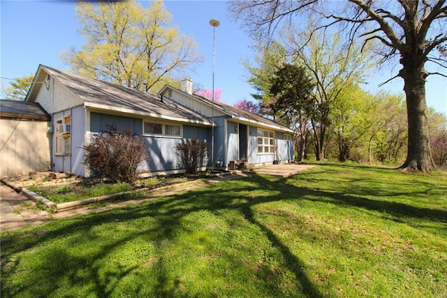 25388 Chieftain Rd, Lawrence, KS 66044 - exterior space featuring a front lawn and a chimney