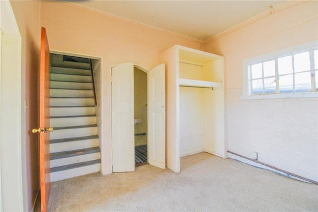 25388 Chieftain Rd, Lawrence, KS 66044 - unfurnished bedroom featuring crown molding, arched walkways, and light colored carpet