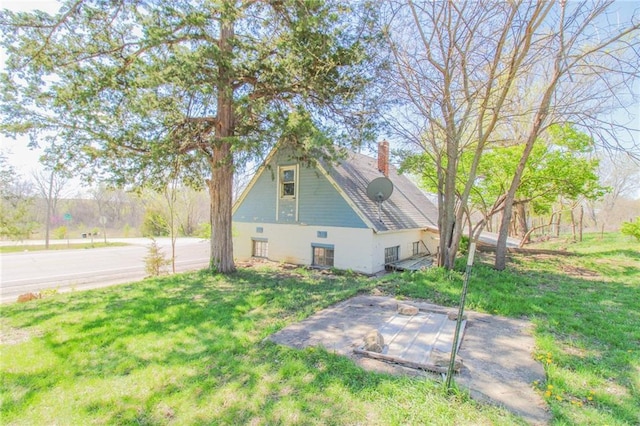 25388 Chieftain Rd, Lawrence, KS 66044 - view of property exterior with a lawn and a chimney