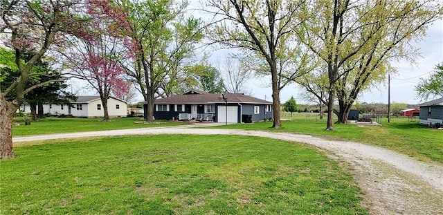 1463 Missouri Rd, Iola, KS 66749 - view of front of property featuring curved driveway, a front lawn, and a garage