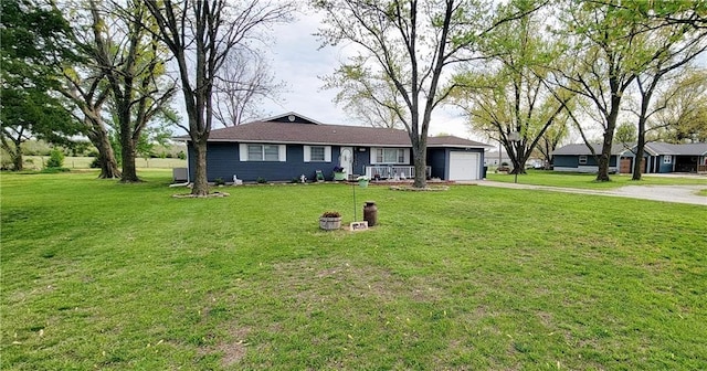 1463 Missouri Rd, Iola, KS 66749 - ranch-style home featuring concrete driveway, a garage, and a front yard