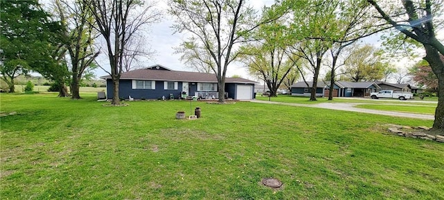 1463 Missouri Rd, Iola, KS 66749 - single story home featuring driveway, a garage, and a front lawn