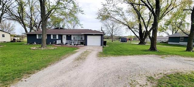 1463 Missouri Rd, Iola, KS 66749 - single story home featuring driveway, a garage, a front yard, and covered porch