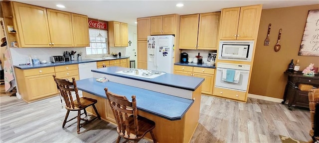 1463 Missouri Rd, Iola, KS 66749 - kitchen with white appliances, light wood-style flooring, a sink, dark countertops, and recessed lighting
