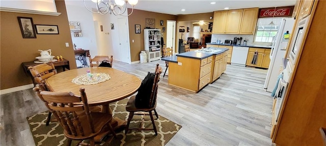 1463 Missouri Rd, Iola, KS 66749 - dining area featuring light wood-type flooring, a chandelier, baseboards, and recessed lighting
