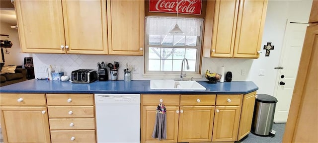 1463 Missouri Rd, Iola, KS 66749 - kitchen with white dishwasher, a sink, dark countertops, tasteful backsplash, and light brown cabinets