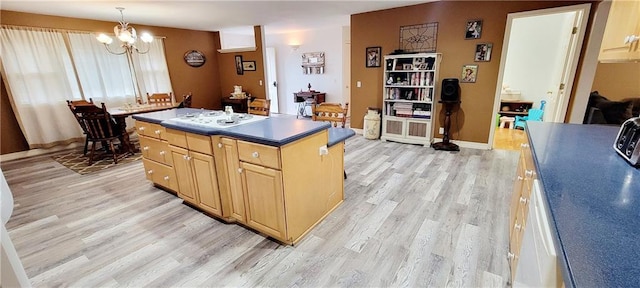 1463 Missouri Rd, Iola, KS 66749 - kitchen featuring light wood finished floors, a chandelier, white cooktop, and a center island