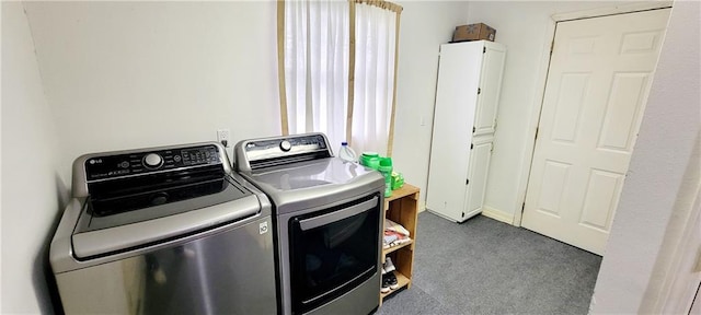 1463 Missouri Rd, Iola, KS 66749 - laundry area featuring washer and clothes dryer, dark carpet, and cabinet space