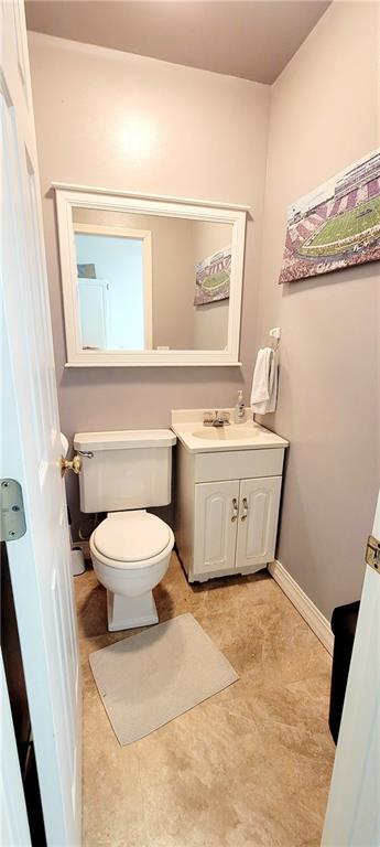 1463 Missouri Rd, Iola, KS 66749 - half bathroom featuring toilet, vanity, and baseboards