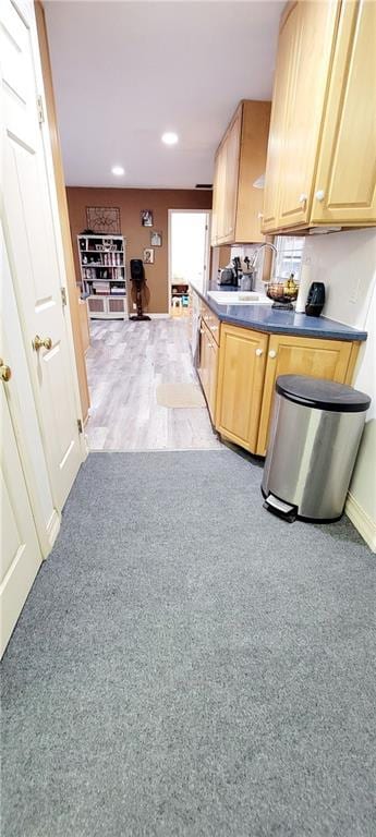 1463 Missouri Rd, Iola, KS 66749 - kitchen featuring baseboards, dark countertops, recessed lighting, healthy amount of natural light, and carpet flooring