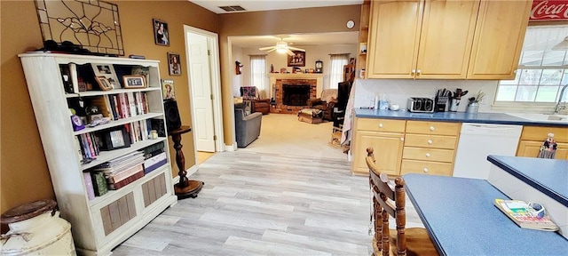 1463 Missouri Rd, Iola, KS 66749 - kitchen featuring white dishwasher, light brown cabinets, light wood finished floors, and a ceiling fan