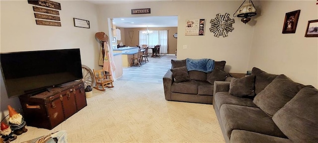 1463 Missouri Rd, Iola, KS 66749 - living area featuring a chandelier and light wood-style floors