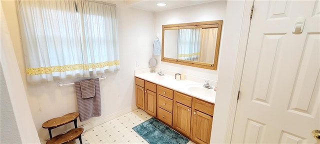 1463 Missouri Rd, Iola, KS 66749 - full bathroom with double vanity, tile patterned floors, and baseboards