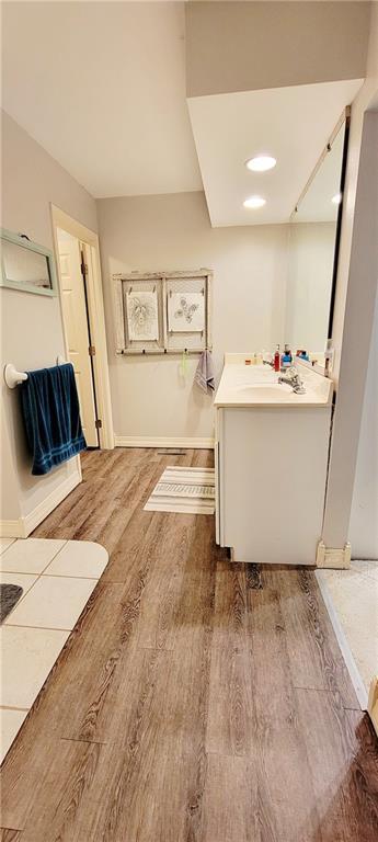1463 Missouri Rd, Iola, KS 66749 - bathroom with wood finished floors, vanity, and baseboards