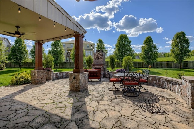 4102 NW 76th Ter, Kansas City, MO 64151 - view of patio with exterior fireplace, a ceiling fan, and outdoor dining space