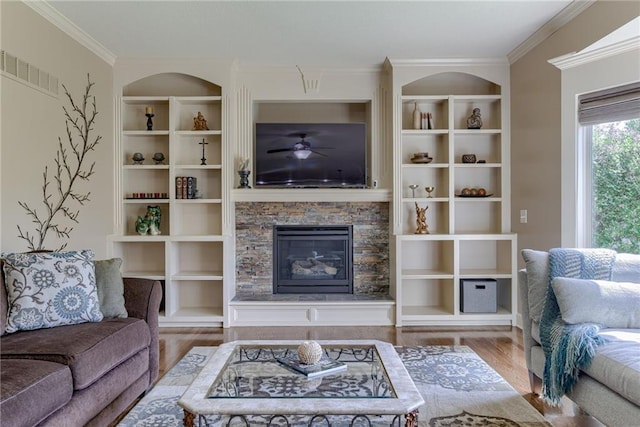 4102 NW 76th Ter, Kansas City, MO 64151 - living room with wood finished floors, a stone fireplace, ornamental molding, ceiling fan, and built in features