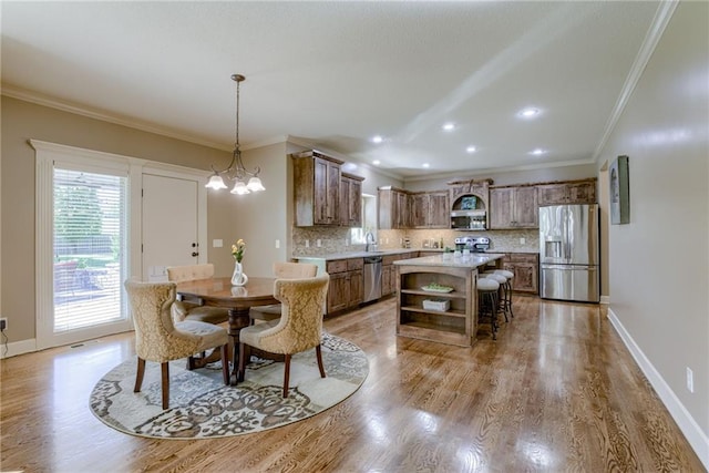 4102 NW 76th Ter, Kansas City, MO 64151 - dining space featuring light wood-style floors, ornamental molding, baseboards, and recessed lighting
