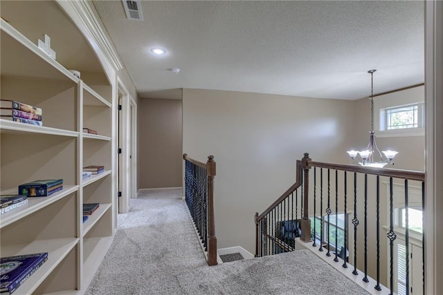 4102 NW 76th Ter, Kansas City, MO 64151 - corridor with a chandelier, a textured ceiling, an upstairs landing, carpet, and recessed lighting