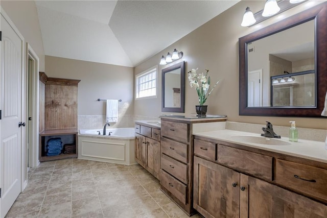 4102 NW 76th Ter, Kansas City, MO 64151 - bathroom with double vanity, a garden tub, tiled shower, lofted ceiling, and tile patterned floors
