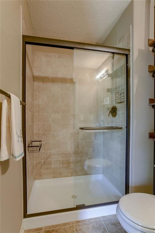 4102 NW 76th Ter, Kansas City, MO 64151 - full bath with toilet, a textured ceiling, a shower stall, and tile patterned floors