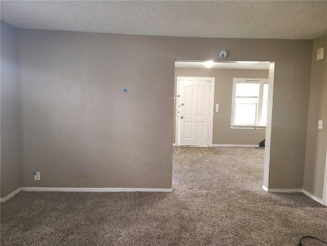 10816 E 27th St, Independence, MO 64052 - spare room with carpet, a textured ceiling, and baseboards