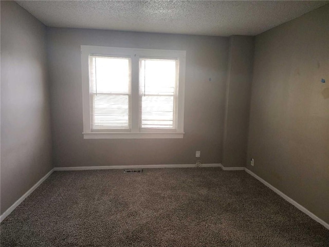 10816 E 27th St, Independence, MO 64052 - carpeted empty room with baseboards, a textured ceiling, and visible vents