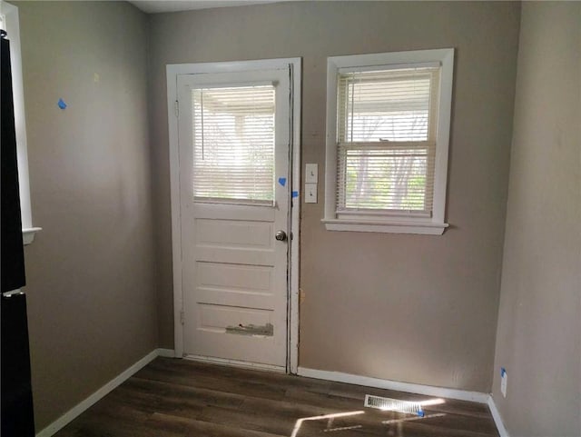 10816 E 27th St, Independence, MO 64052 - doorway to outside featuring baseboards and dark wood finished floors