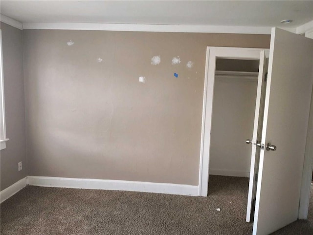 10816 E 27th St, Independence, MO 64052 - unfurnished bedroom with baseboards, carpet floors, and a closet