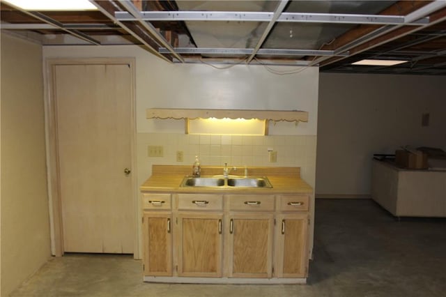 1410 Grandview Dr, Warrensburg, MO 64093 - kitchen featuring a sink, light countertops, concrete floors, and tasteful backsplash