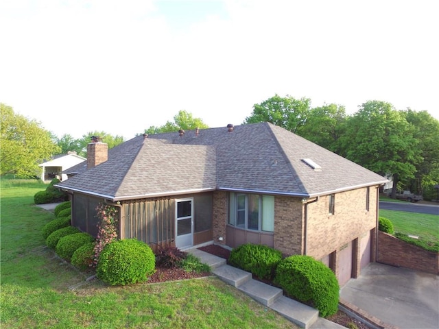 1410 Grandview Dr, Warrensburg, MO 64093 - view of front facade featuring a chimney, concrete driveway, a front yard, roof with shingles, and a garage