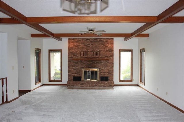 1410 Grandview Dr, Warrensburg, MO 64093 - unfurnished living room with carpet floors, beam ceiling, baseboards, ceiling fan, and a fireplace
