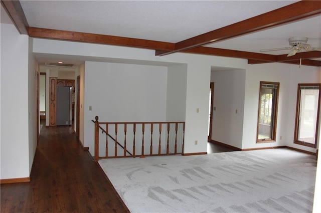 1410 Grandview Dr, Warrensburg, MO 64093 - empty room with beam ceiling, baseboards, wood finished floors, and ceiling fan