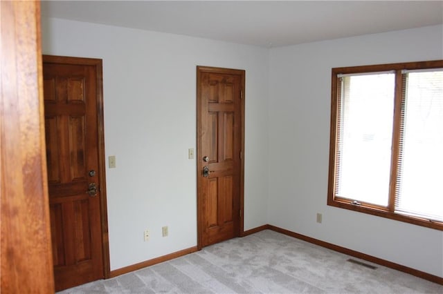 1410 Grandview Dr, Warrensburg, MO 64093 - spare room featuring light colored carpet and baseboards