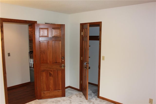 1410 Grandview Dr, Warrensburg, MO 64093 - unfurnished bedroom featuring baseboards, light carpet, and a spacious closet