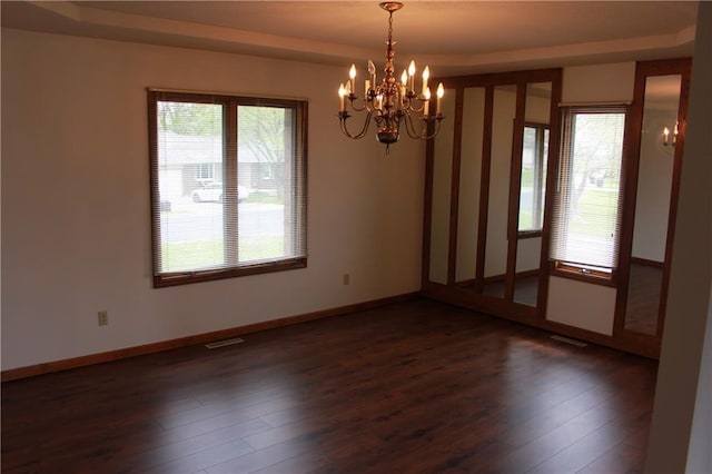 1410 Grandview Dr, Warrensburg, MO 64093 - unfurnished room featuring a chandelier, plenty of natural light, and wood finished floors