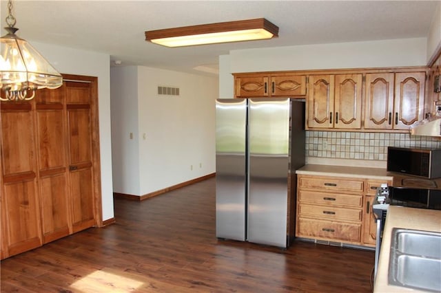 1410 Grandview Dr, Warrensburg, MO 64093 - kitchen with appliances with stainless steel finishes, a chandelier, light countertops, tasteful backsplash, and a sink