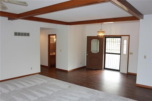 1410 Grandview Dr, Warrensburg, MO 64093 - entryway with beam ceiling, a chandelier, baseboards, dark carpet, and dark wood-style flooring