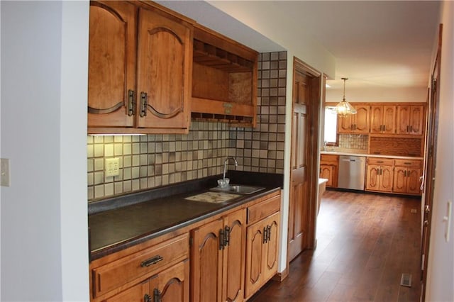 1410 Grandview Dr, Warrensburg, MO 64093 - kitchen with dishwasher, backsplash, brown cabinets, a sink, and dark countertops