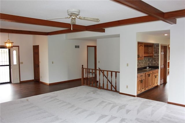 1410 Grandview Dr, Warrensburg, MO 64093 - living room with beam ceiling, dark wood-style flooring, and baseboards