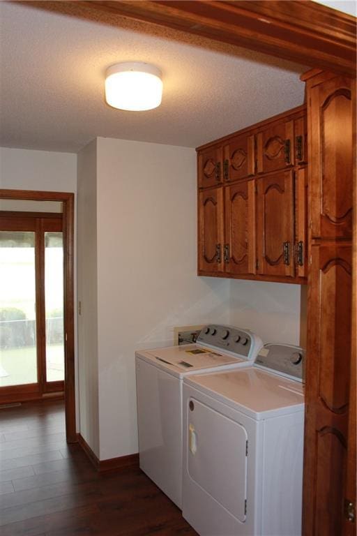 1410 Grandview Dr, Warrensburg, MO 64093 - washroom with cabinet space, washing machine and dryer, baseboards, and dark wood-type flooring