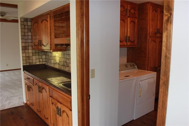 1410 Grandview Dr, Warrensburg, MO 64093 - laundry room featuring cabinet space, washer and clothes dryer, baseboards, a ceiling fan, and dark wood-type flooring