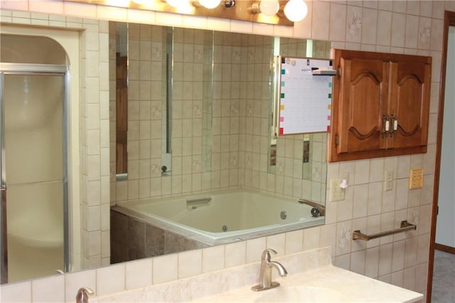 1410 Grandview Dr, Warrensburg, MO 64093 - bathroom featuring a jetted tub, an enclosed shower, and vanity