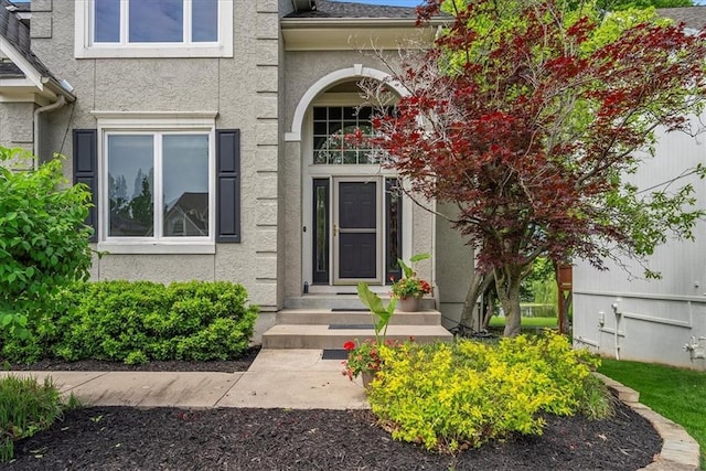 entrance to property with stucco siding